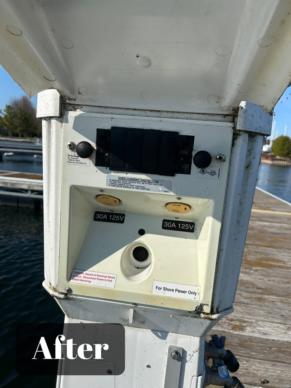 Dockside electrical panel with 30A 125V outlets for shore power access.