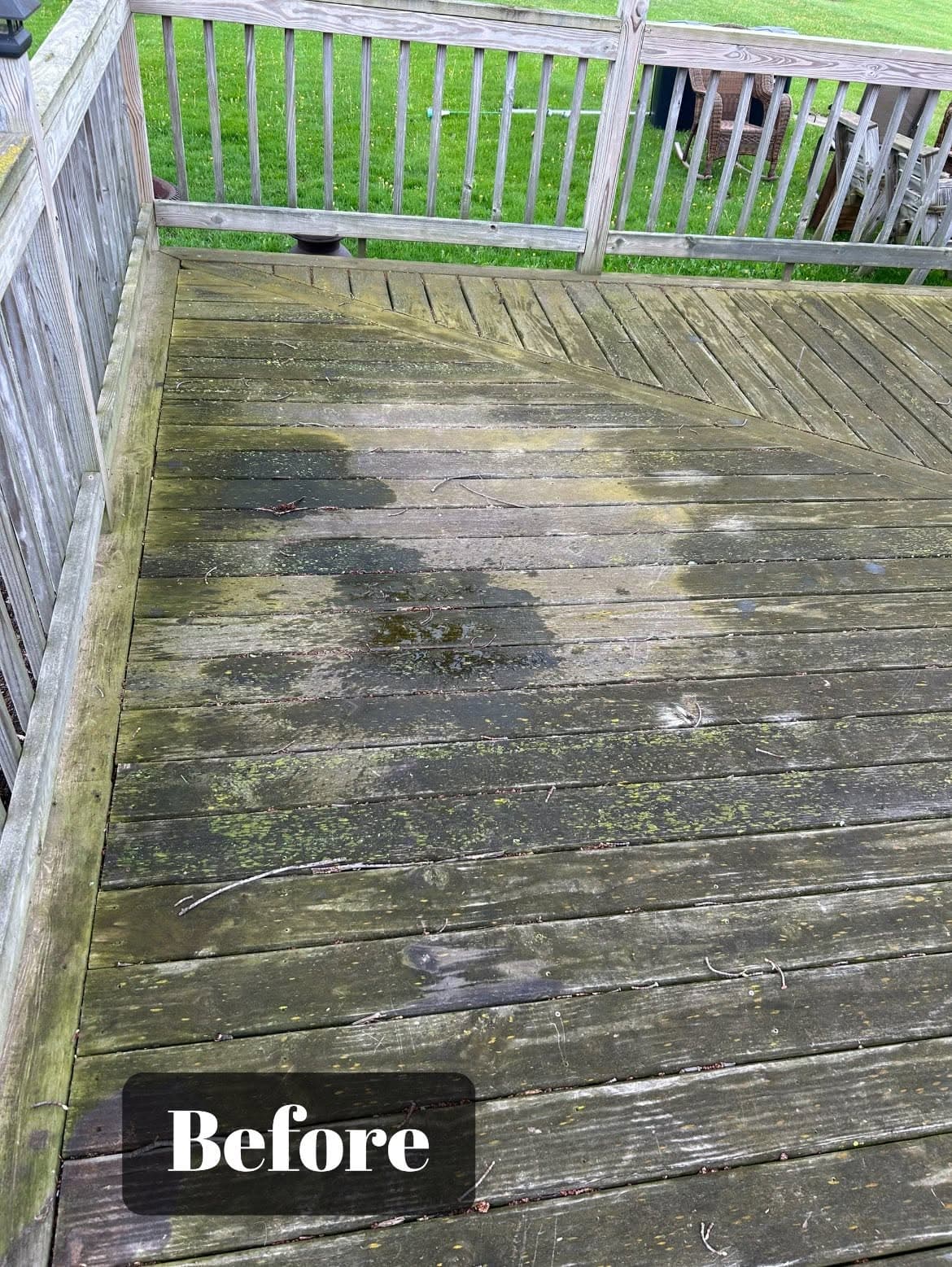 Before cleaning, a weathered wooden deck shows signs of mildew and dirt buildup.